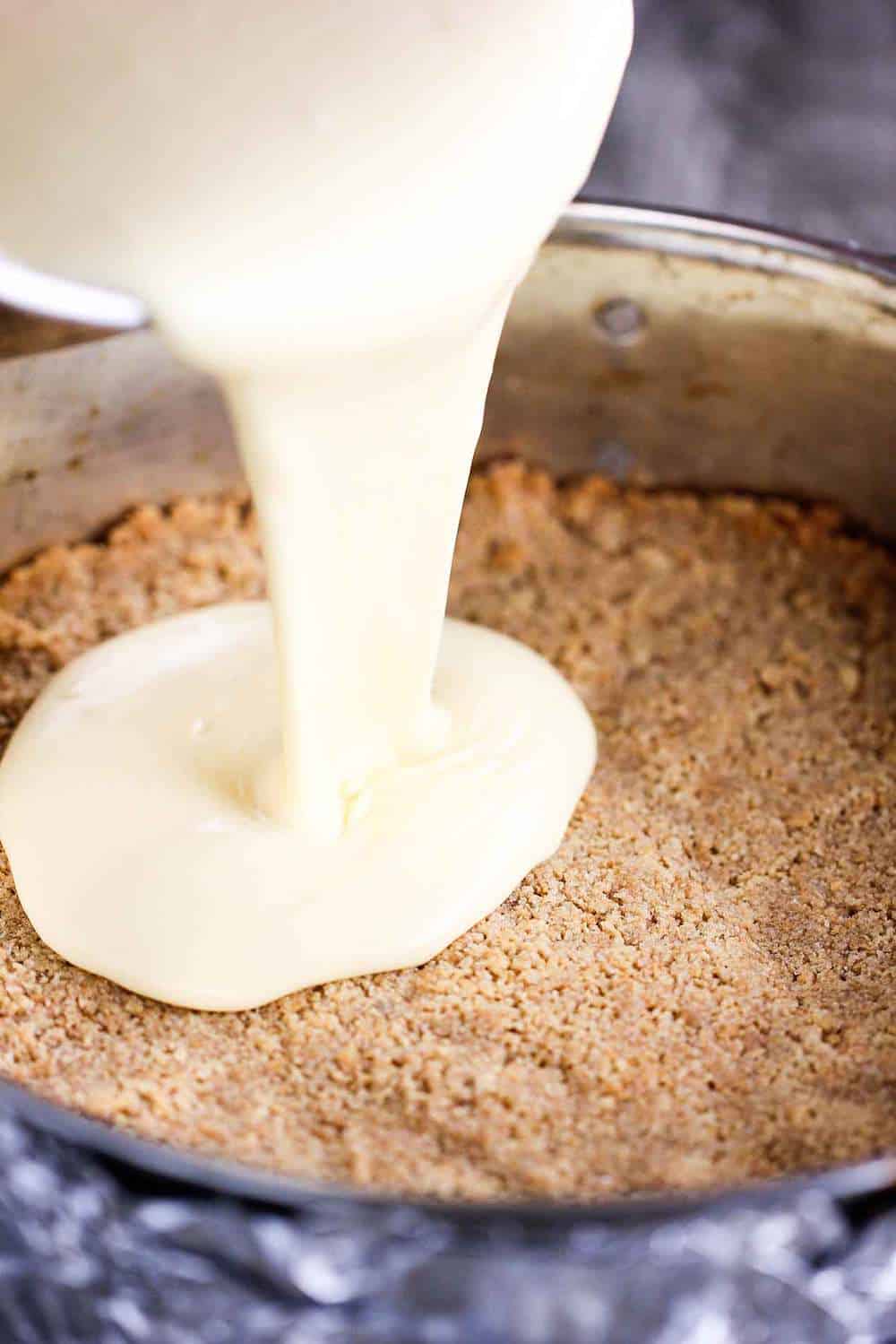 Custard pouring into a springform pan for New York Cheese Cake.