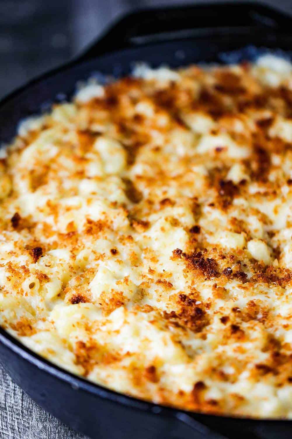 A large black cast iron skillet of the ultimate macaroni and cheese.
