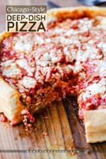 A Chicago-style deep dish pizza with a slice missing sitting on a wooden cutting board.