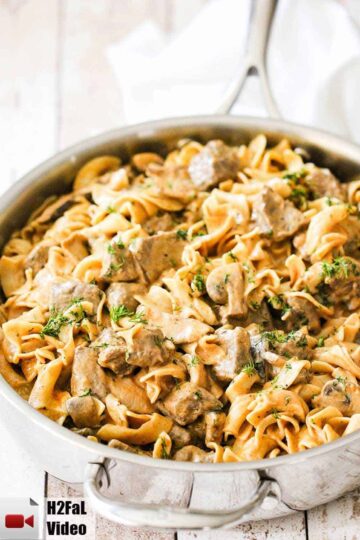 A large silver saucepan filled with gourmet beef stroganoff