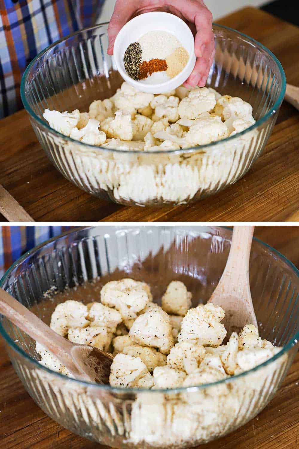 A person sprinkling seasonings from a small bowl over cut cauliflower in a large glass bowl, and then 2 spoons toss it all together.
