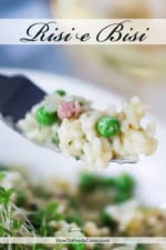 A fork being held up with risi e bisi on it.