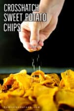 A hand sprinkling coarse sea salt over freshly made cross hatch sweet potato chips.