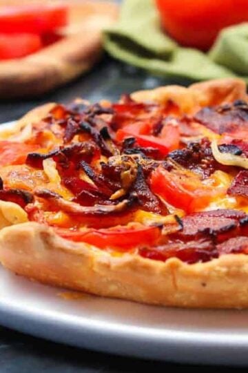 Tomato Cheddar and Bacon Pie on a white plate