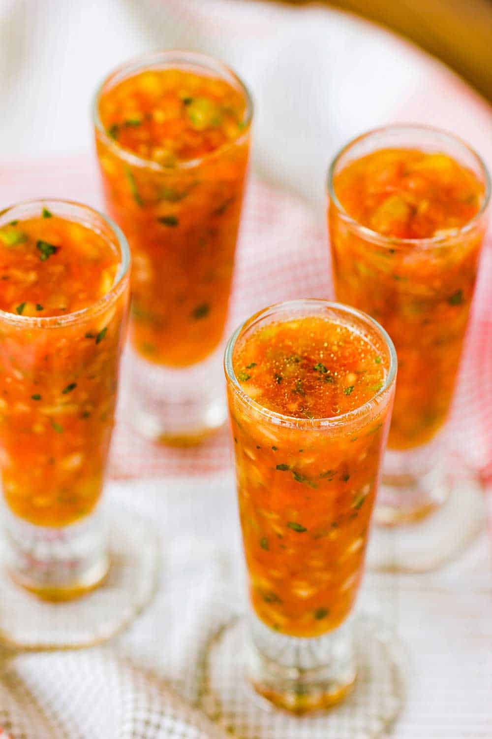 Pour classic gazpacho into chilled shot glasses for serving at a party.