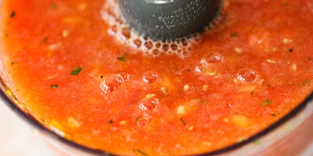 Liquify the tomatoes in a food processor.