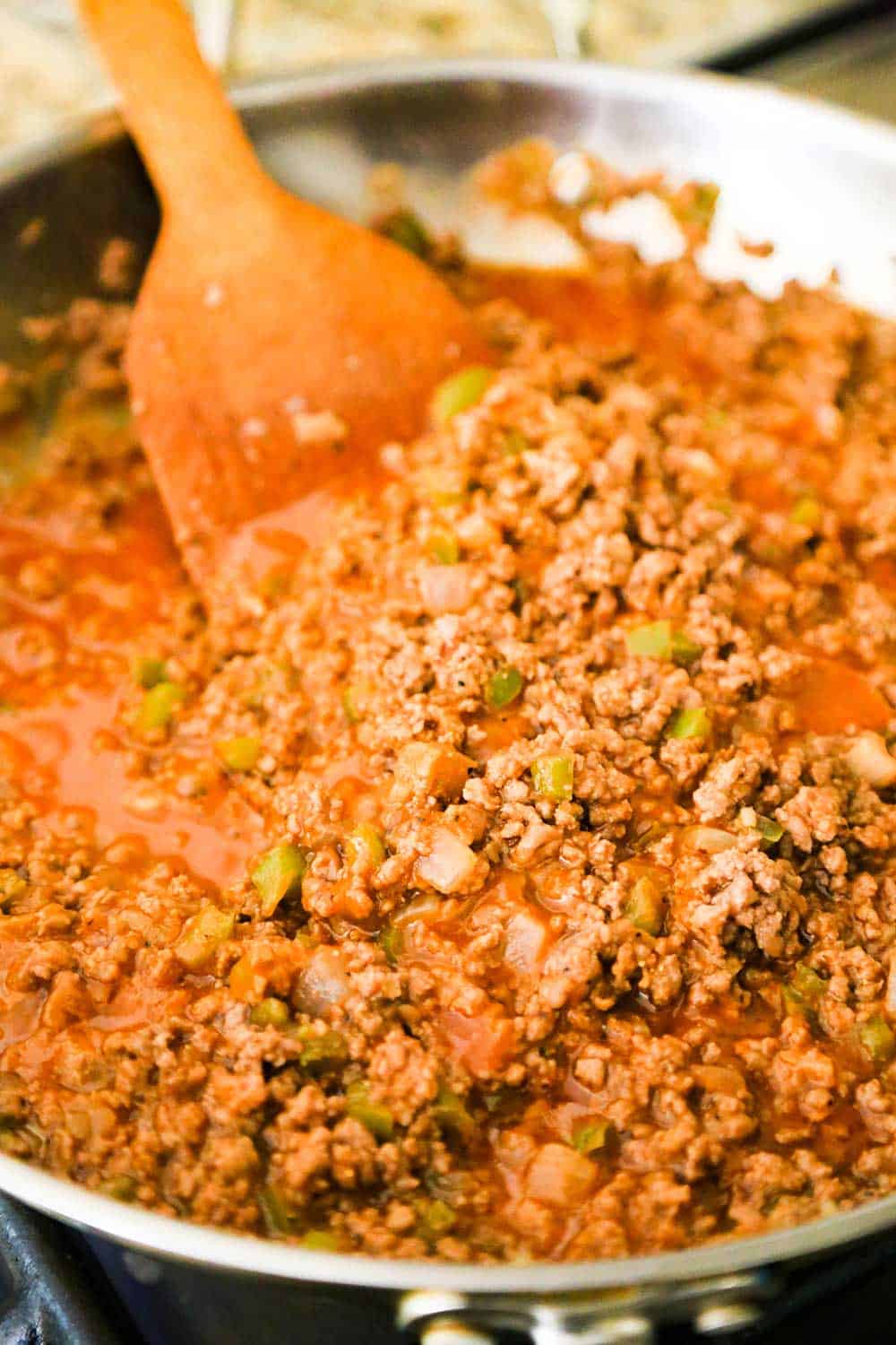 A large silver skillet filled with juicy sloppy joes mixture.
