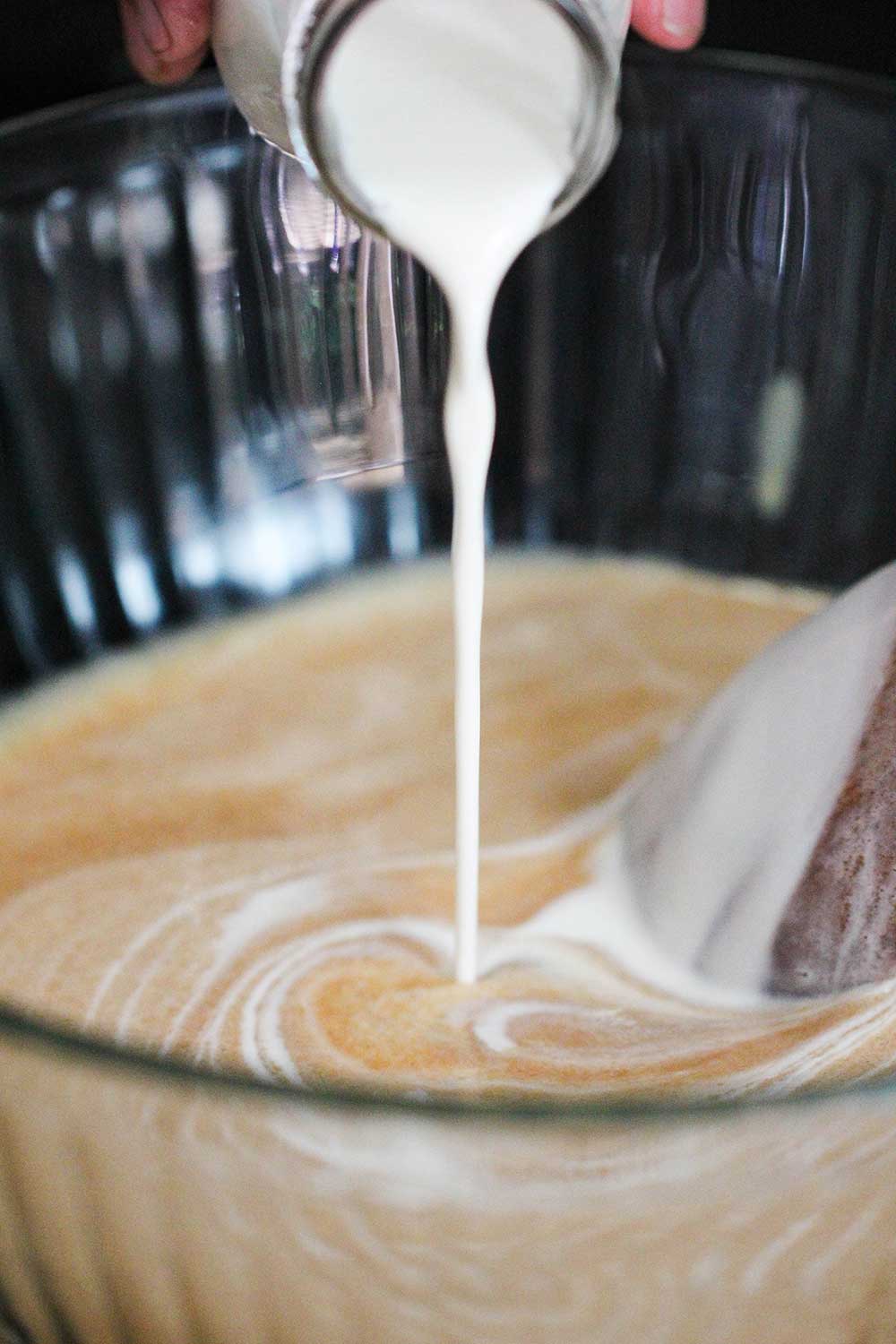 Pour the cream into the peanut butter custard for the peanut butter ice cream.