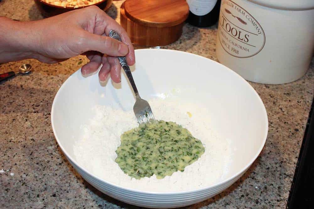 A large bowl of flour and egg mixture for homemade German spaetzle