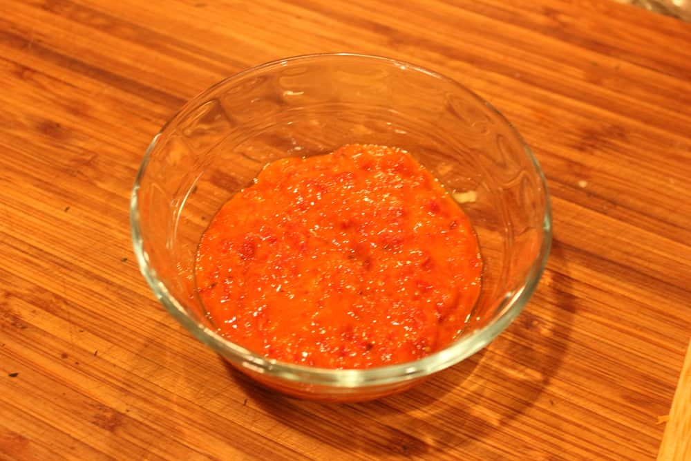 A small glass bowl containing fresh tomato sauce dressing for spiralized ratatouille.