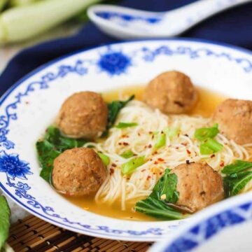 Asian Fusion Wedding Soup in a patterned bowl next to a dark napkin
