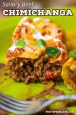 A close-up view of a juicy ground beef chimichanga on a plate and it has been split open to review the meaty insides.
