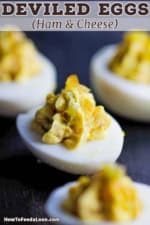 Ham and cheese deviled eggs on a dark plate.