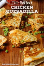 Triangle shapes of chicken quesadilla haphazardly scattered around on a large wooden cutting board.