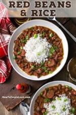 An overhead view of two white bowls filled with servings of red beans and rice with a small bottle of hot sauce and a beer in a tall glass nearby.