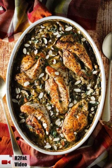 A large oval baking dish of baked chicken and sage casserole.