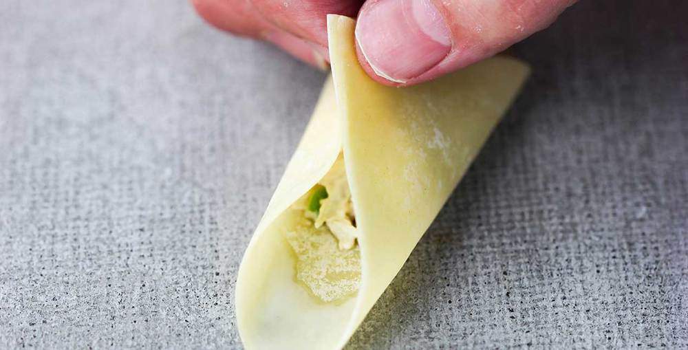 Wonton wrapper pinched together for crab rangoon