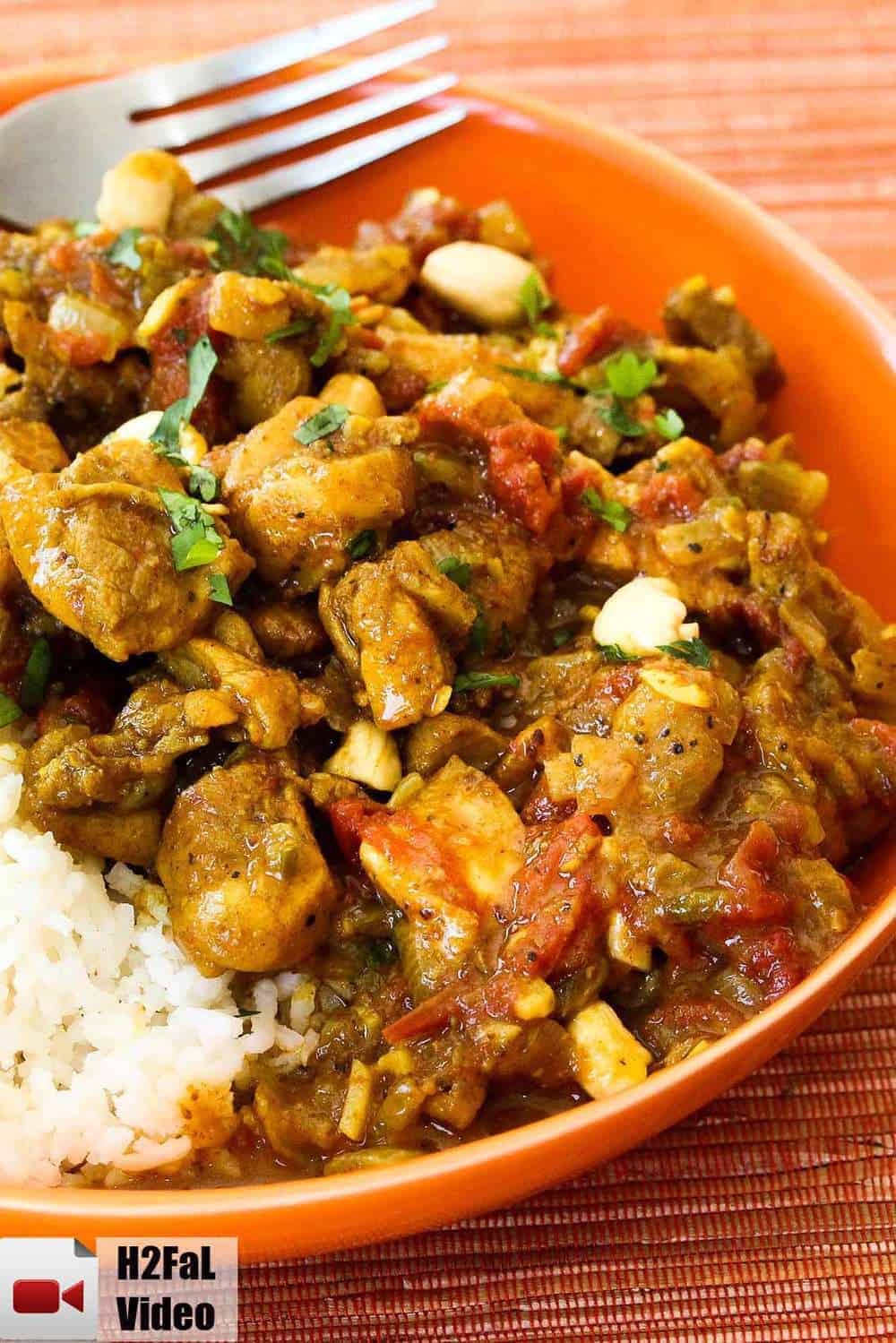 Authentic chicken curry in an orange bowl