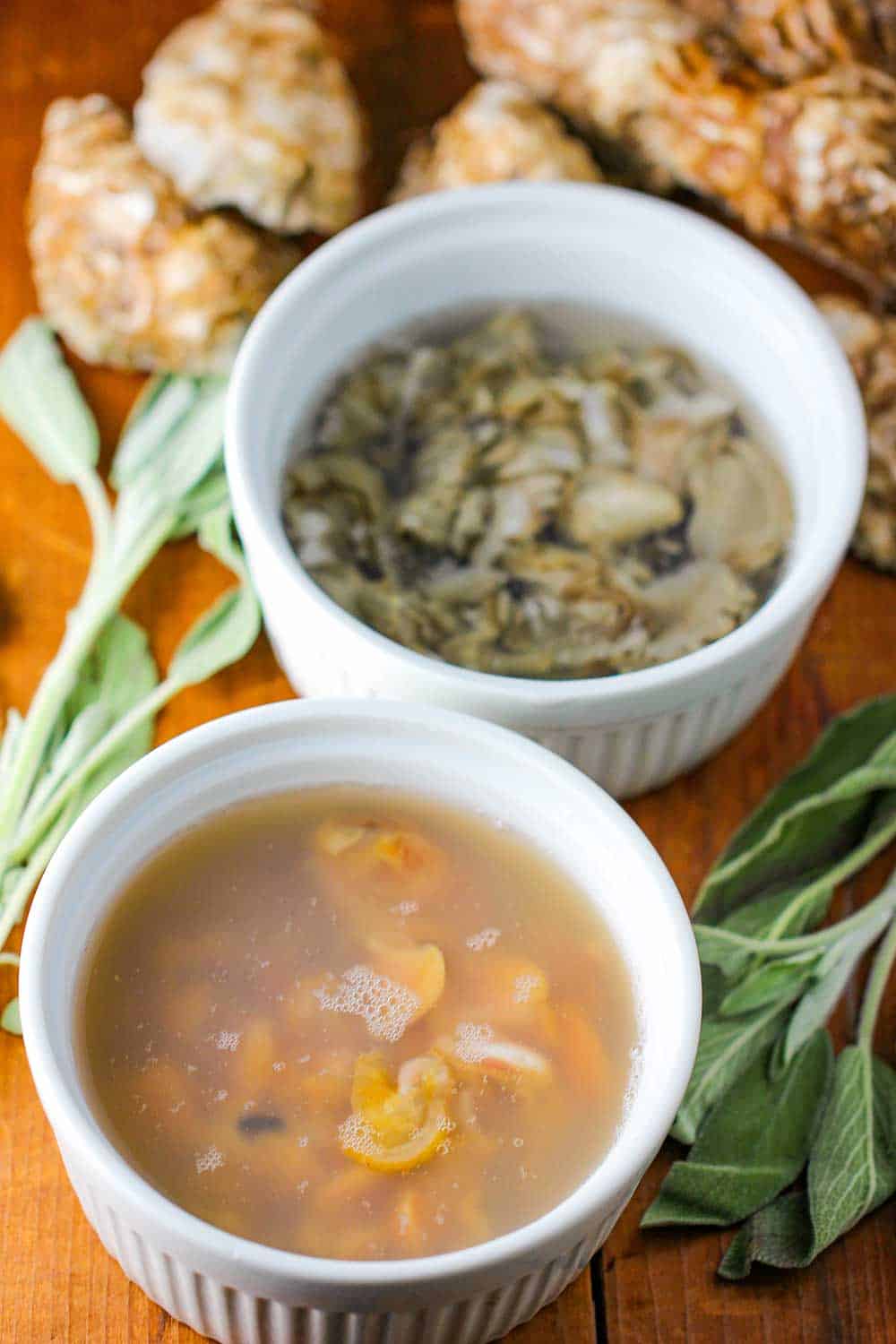 A bowl of shucked oysters and a bowl of shucked clams for fried oysters and clams.