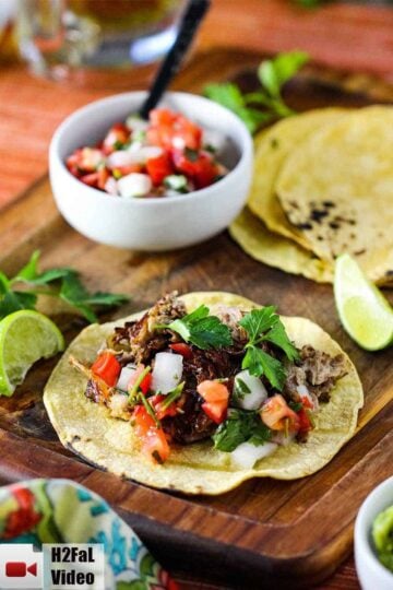 Place the shredded pork carnitas on a corn tortilla with pico de Gallo, cilantro and fresh lime.