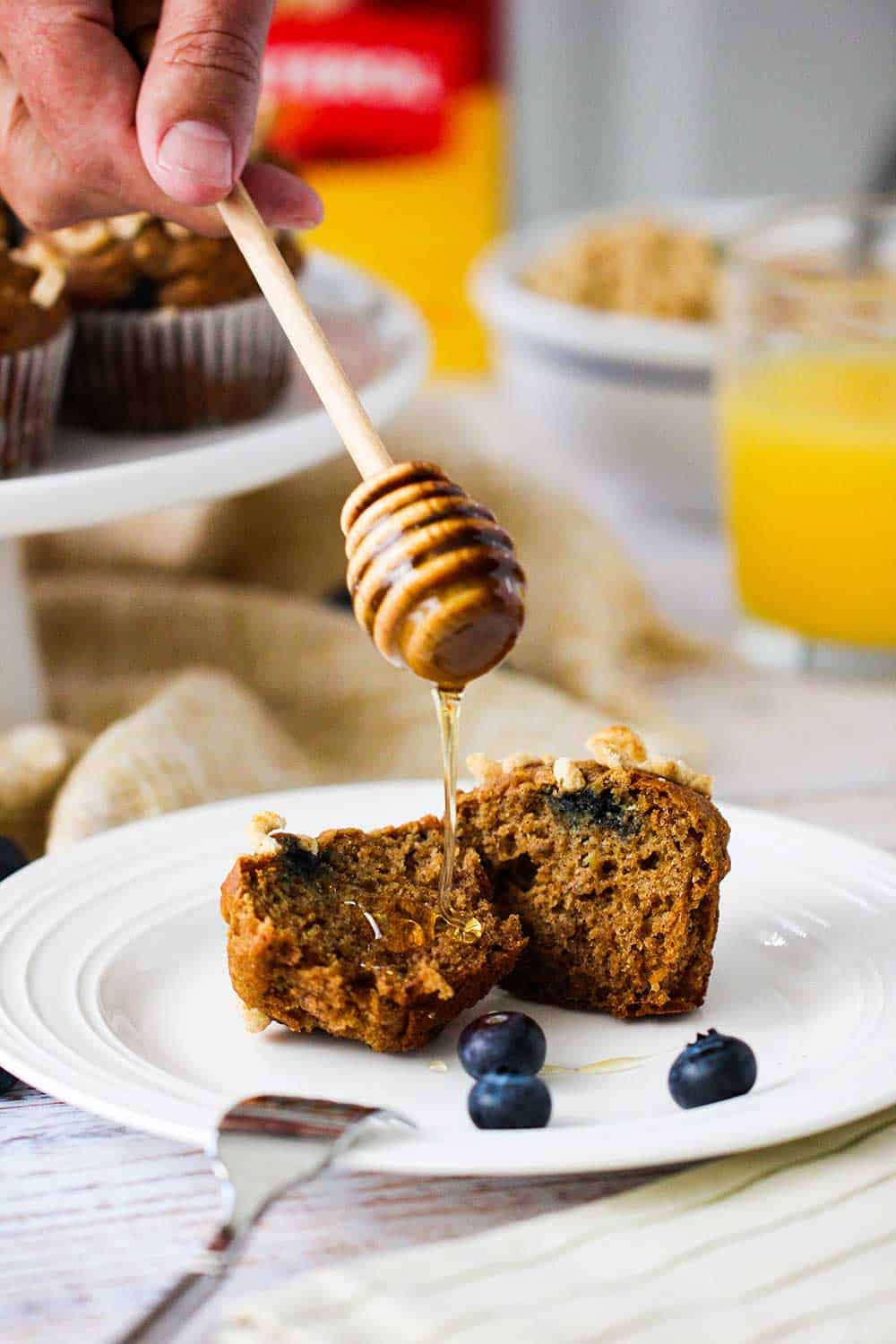 Drizzle fresh honey on banana blueberry muffins.