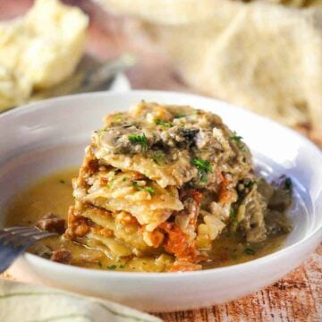 A white bowl of slow-cooker ham and potatoes au gratin.