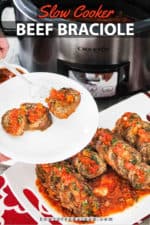 A close up view of slow cooker beef braciole on a white platter next to a Crock-Pot.