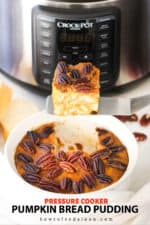 A slice of pumpkin bread pudding being lifted out of a dish in front of a pressure cooker.
