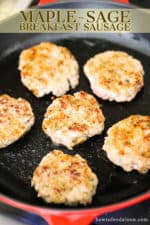 A large black skillet with orange exterior filled with 5 cooked maple sausage patties.