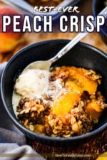 A blue dessert bowl filled with a helping of peach crisp with a scoop of melting vanilla ice cream on top.
