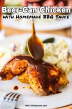 A person using a spoon to drizzle barbecue sauce over a grilled beer can chicken leg quarter.