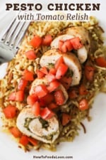 A close-up view of plate filled with sliced pesto-stuffed chicken with tomato relish all on a bed of rice pilaf.