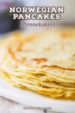 A close-up view of a stack of very thin crepe-like Norwegian pancakes resting on a white circular dish.