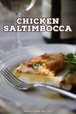 A straight-on view of a half eat chicken saltimbocca cutlet that is topped with crispy prosciutto and a fresh sage leaf.