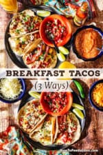 An overhead view of two large black plate filled with breakfast tacos that are stuffed with eggs, chorizo, bacon, potatoes, and sitting next to a bowl of pico de gallo.