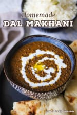 A straight-on view of a colorful blue bowl that is filled with a serving of dal makhani with another bowl of cooked basmati rice in the background.