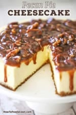 A close-up view of a cheesecake topped with a pecan pie sauce with a slice of cake missing.