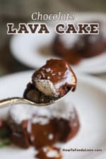 A spoon being raised with a serving of gooey chocolate lava cake on it with the half-eaten cake in the background.