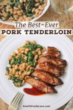 An overhead view of a white dinner plate that is filled with a serving of sliced best-ever pork tenderloin topped with a cranberry reduction and next to a serving of sautéed white beans and spinach.