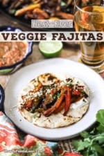 A straight-on view of single serving of veggie fajitas on a white plate next to a tall glass of beer with a festive bowl of salsa in the background.
