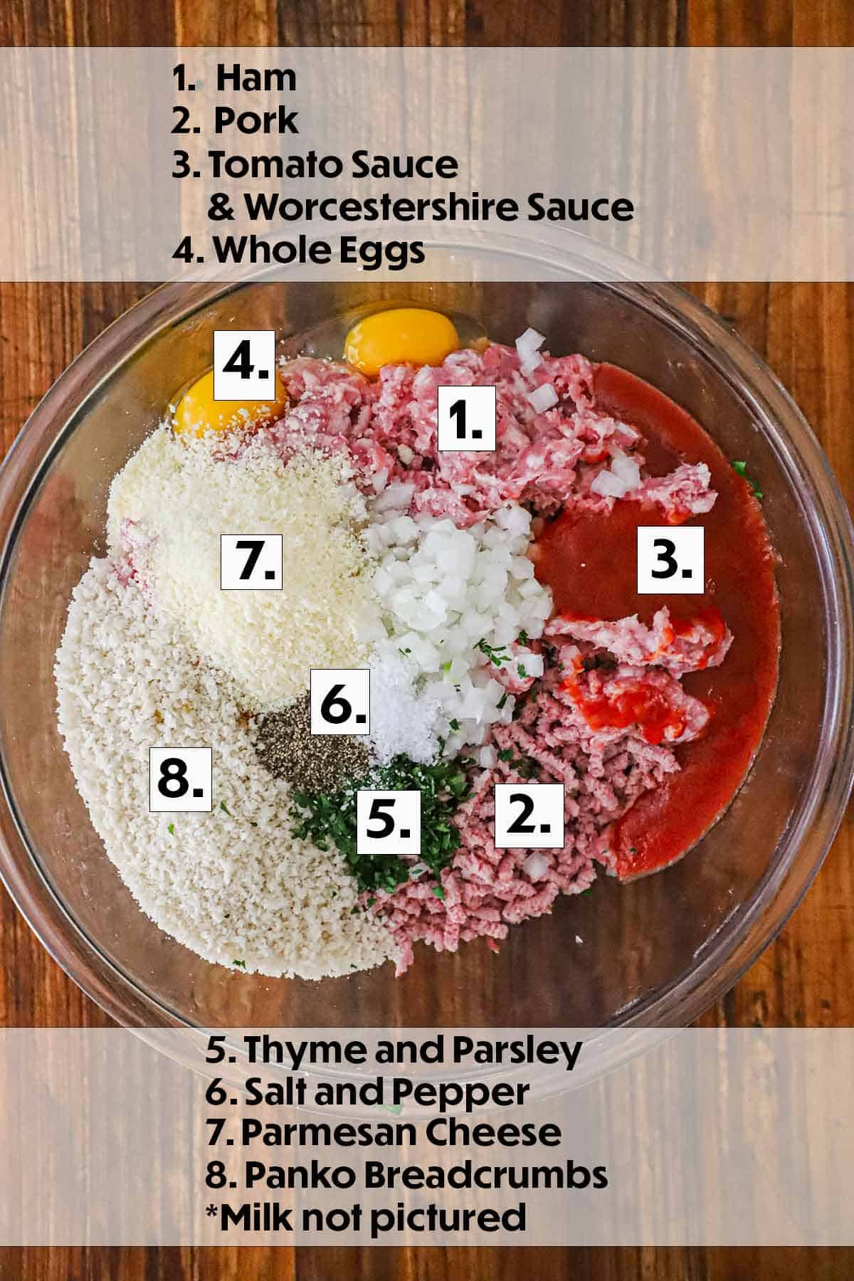 A large glass bowl filled with ground pork and ham, breadcrumbs, eggs, and seasonings for glazed ham loaf.