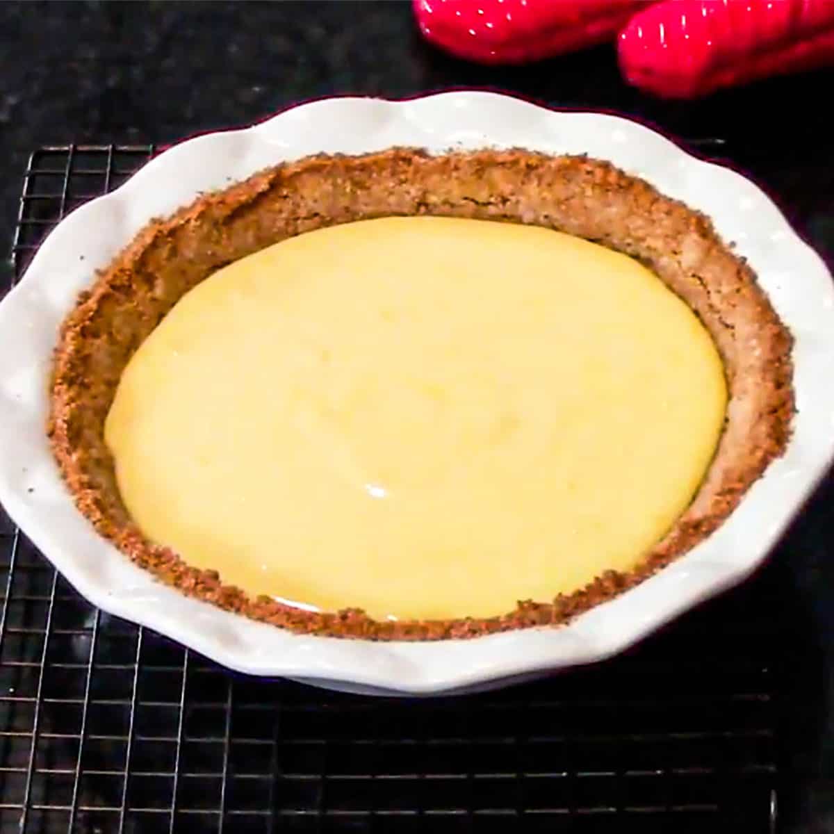 An easy key lime pie that has just out of the oven and is waiting to be chilled for several hours.
