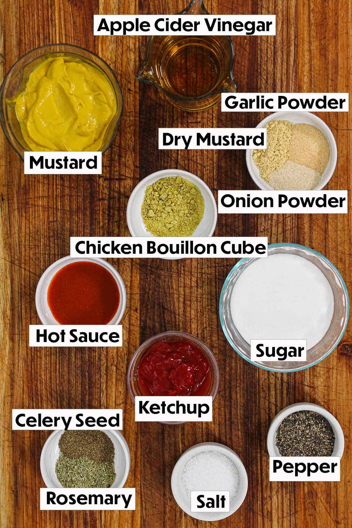 The ingredients for Carolina mustard sauce arranged on a wooden background, including yellow mustard, apple cider vinegar, sugar, Worcestershire sauce, and spices, all neatly organized for easy preparation.