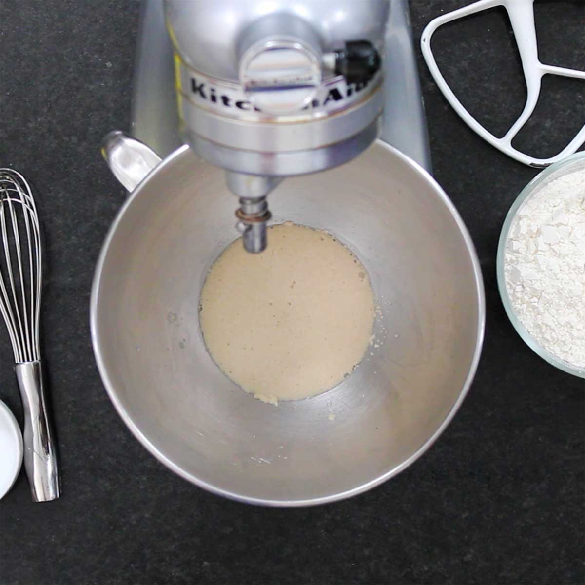 Foamy yeast in warm water in the bowl of a stand mixer.