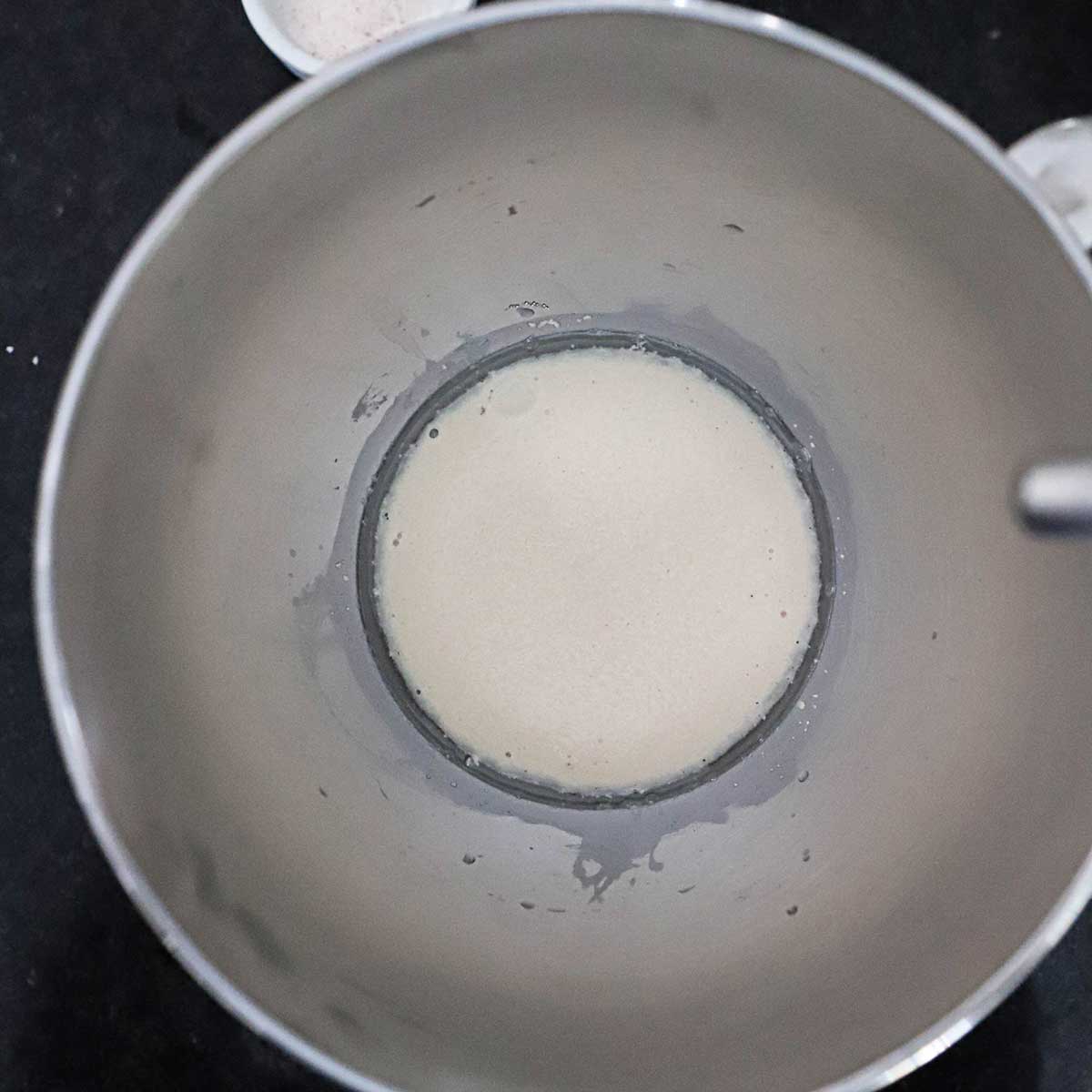 Yeast that has been activated in warm water and has become foamy in the bottom of a stand mixer bowl.