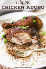 A partially eaten chicken thigh from a plated serving of Filipino chicken adobo.